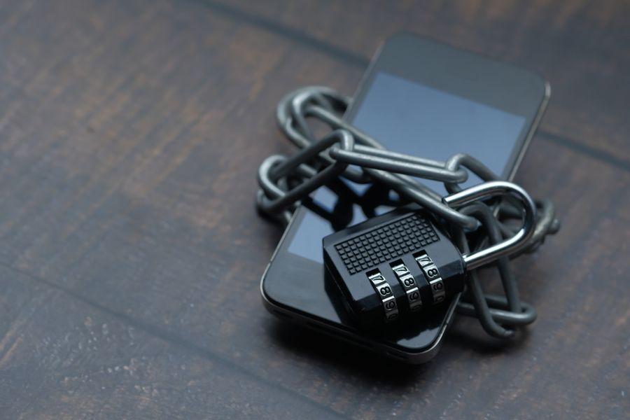 Smartphone secured with a chain and padlock