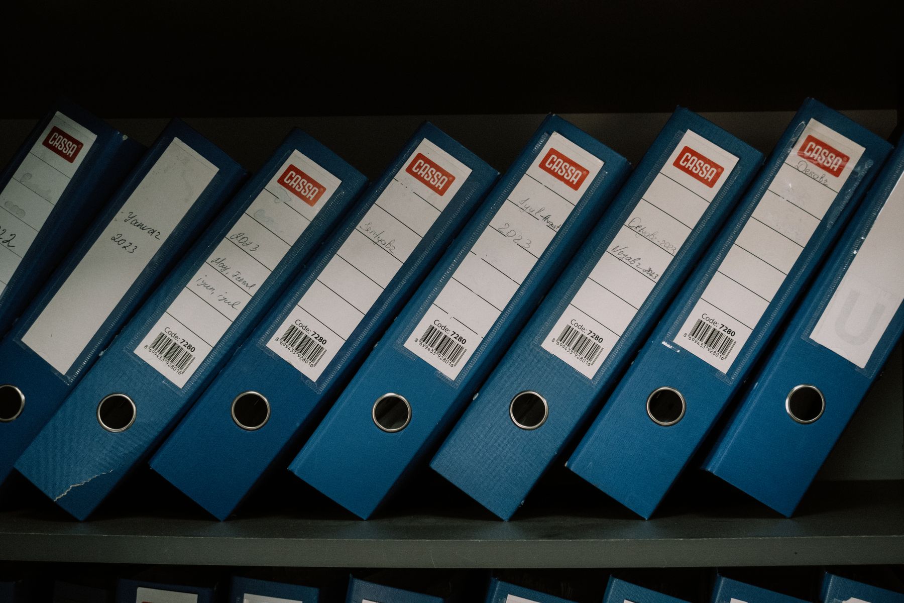 Organised office binders on a shelf